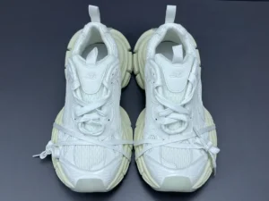 Balenciaga 3XL Mesh sneakers in white, featuring a chunky design and lace-up closure, displayed on a dark background, representing luxury footwear available for purchase.