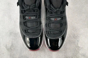 Nike Air Jordan 11 Retro Bred black white red patent leather sneakers with mesh upper and lace closure