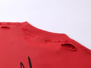 Repsgoat distressed red crew neck shirt cotton fabric with worn holes near shoulder and neck seam