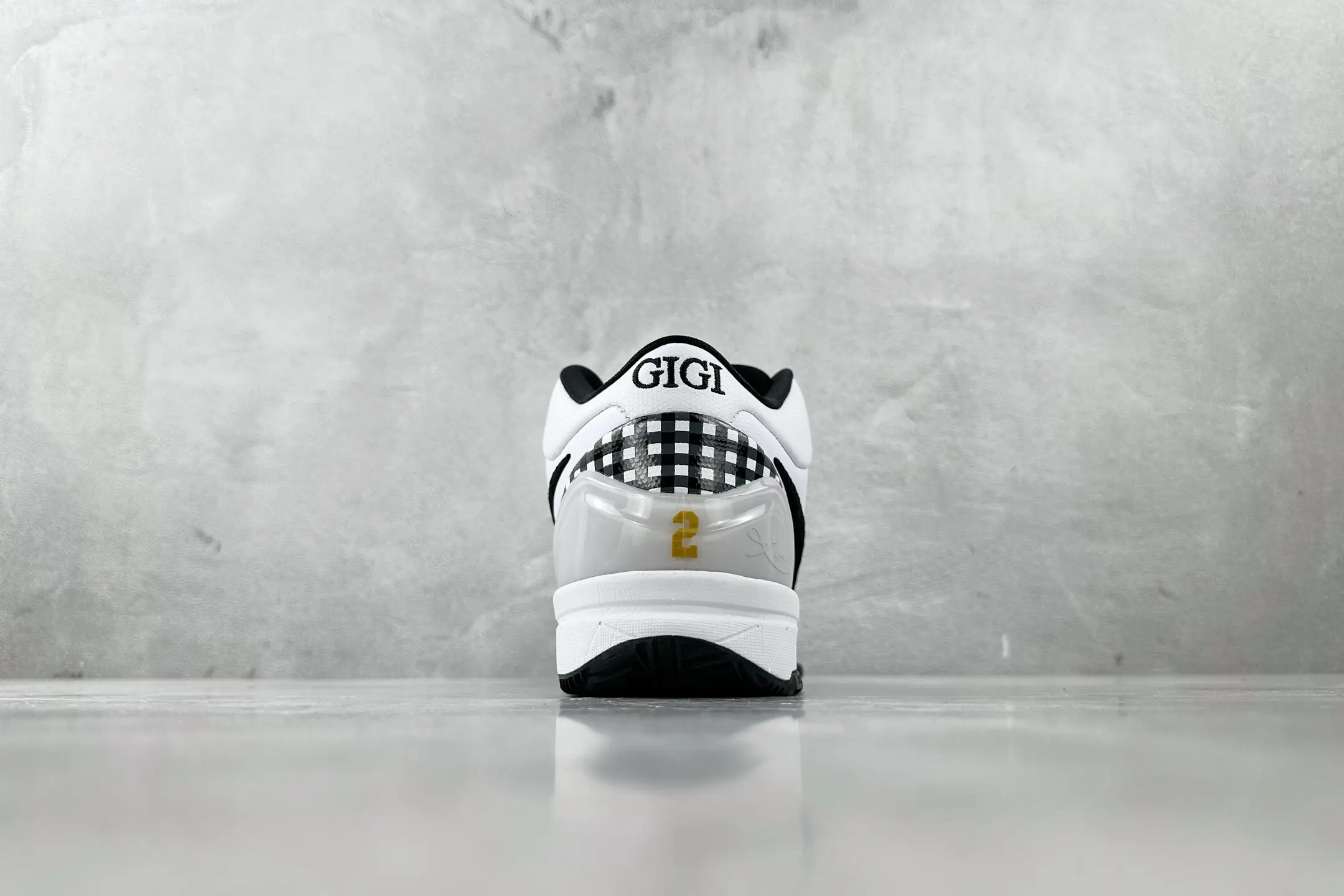 Nike Zoom Kobe 4 "Mambacita" G shoes featuring a white and black design, "GIGI" embroidered on the heel, and the number "2" in gold on the back.