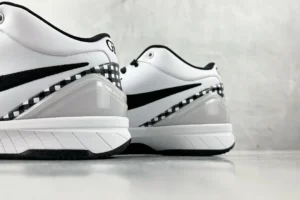 Nike Zoom Kobe 4 "Mambacita" G sneakers in white and black, showcasing distinctive design elements and textured detailing.