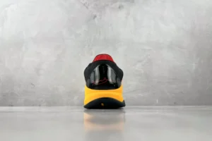 Nike Air Zoom Vomero 5 black red yellow mesh sneakers viewed from the back with reflective detail on heel