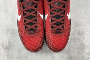 Nike Zoom Kobe 6 Protro "All-Star" sneakers featuring a red textured upper, black laces, and white swoosh logo, displayed on a gray surface.