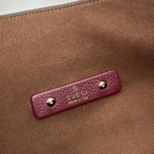 Gucci bag interior label burgundy leather gold-tone studs brown suede lining