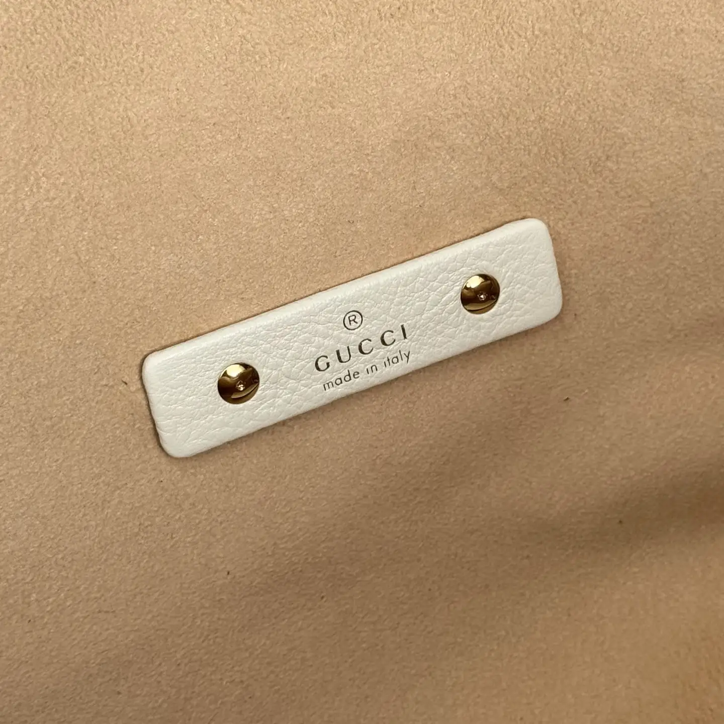 Gucci bag interior label white leather tag gold rivets made in Italy on beige suede lining