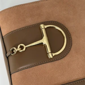 Gucci handbag brown suede and leather with gold metal horsebit detail close-up