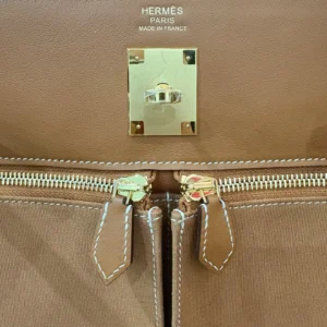 Hermes Kelly Lakis 28 handbag interior featuring gold hardware, zippers, and embossed logo, showcasing luxury craftsmanship and design details.