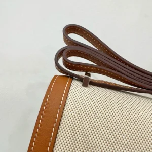 Hermès Evelyne TPM bag canvas brown leather strap visible stitching close-up