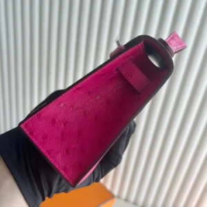 MiniKelly Pocket 22cm East handbag interior view showcasing vibrant pink lining and craftsmanship details.