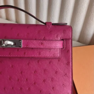MiniKelly Pocket 22cm East handbag in pink ostrich leather, showcasing detailed craftsmanship and luxury design elements.