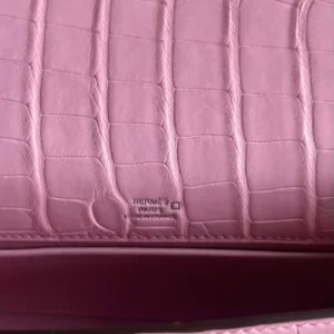 Hermès bag pink crocodile leather close-up with embossed Hermès Paris Made in France logo