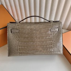 Hermès Kelly 28 taupe gray crocodile leather top handle bag with structured silhouette