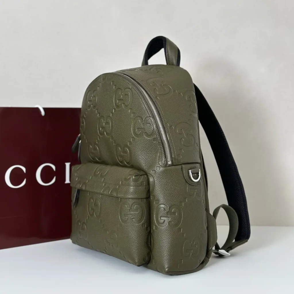 Gucci GG embossed backpack medium olive green leather bag with front pocket and black straps