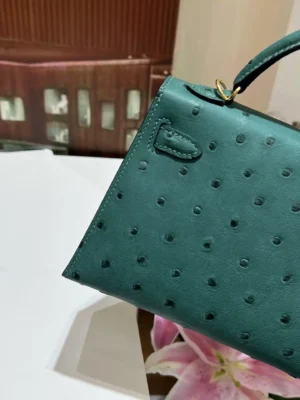 Hermès Kelly 25 small green ostrich leather handbag with gold hardware and top handle strap
