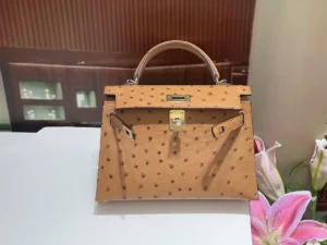 Herm&egrave;s Kelly 28 tan ostrich leather handbag with gold hardware and top handle