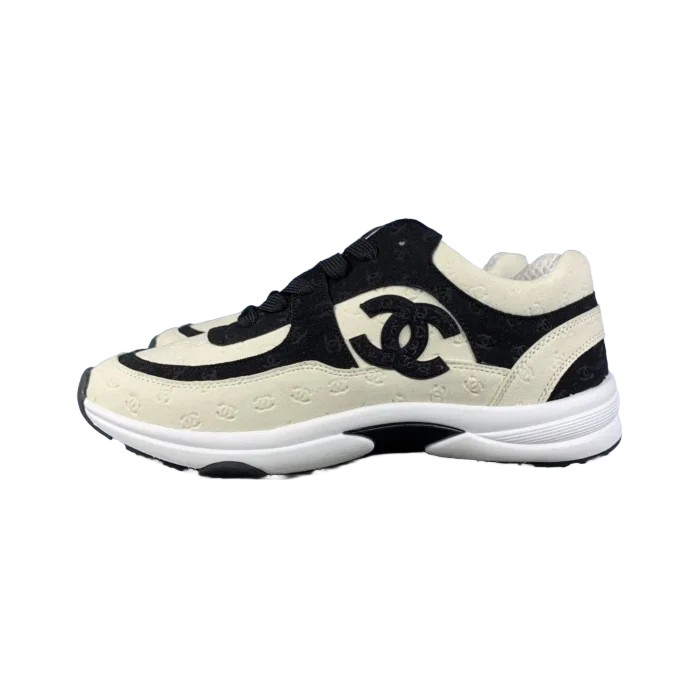 Chanel casual sneakers featuring a black and white design with logo detailing, showcased for purchase on RepsGoat.