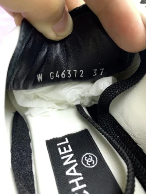 Chanel 25P series casual sports shoes interior showing label with SKU G46372 and size 37, emphasizing luxury craftsmanship and quality materials.