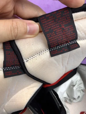 Nike Air Jordan 1 High OG black red white leather sneakers with detailed inner label stitching close-up