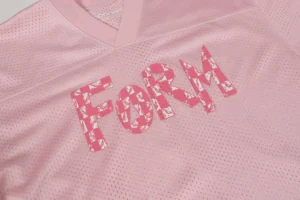 FOAM breathable mesh sports jersey pink fabric with patterned logo lettering