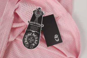 Chrome Hearts logo tags black and white printed on pink perforated fabric garment