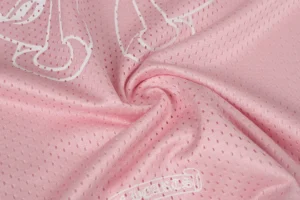 Supreme mesh jersey pink polyester fabric with white graphic print close-up texture swirl