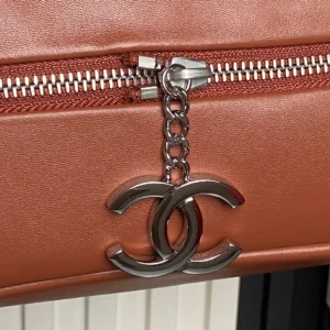 Chanel bag zipper pull silver-tone metal charm on brown leather accessory