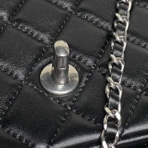 Close-up of Chanel 25B Exquisite Double C-Button CF Series AS5 bag featuring quilted black lambskin, silver chain strap, and metal button closure, highlighting luxurious craftsmanship and design details.