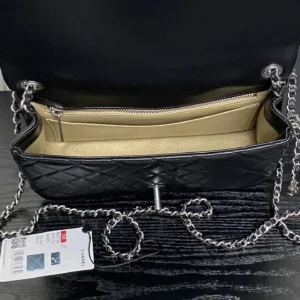 Interior view of the Silver Chain Chanel 25B Exquisite Double C-Button CF Series AS5 bag, featuring a black quilted design, gold lining, and silver chain strap, highlighting its luxurious appeal and practical capacity.