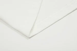 White fabric detail showcasing the texture and seam of a Vivienne Westwood t-shirt, featured in a summer special offer for .00.