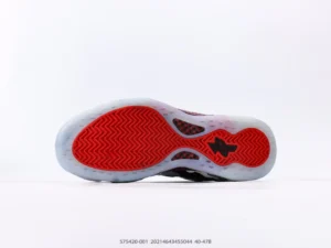 Nike Air Foamposite One sneaker sole with distinctive red and black design, showcasing premium craftsmanship and unique traction pattern.