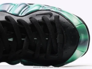 Nike Air Foamposite One black metallic green leather sneakers close-up view of toe and laces