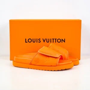 Louis Vuitton Miami Damier Round Head One Word Slippers in vibrant orange, displayed with matching orange box, emphasizing luxury footwear design and brand identity.