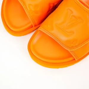 Louis Vuitton Miami Damier Round Head One Word Slippers in vibrant orange, showcasing embossed logo and sleek design, ideal for luxury footwear enthusiasts.