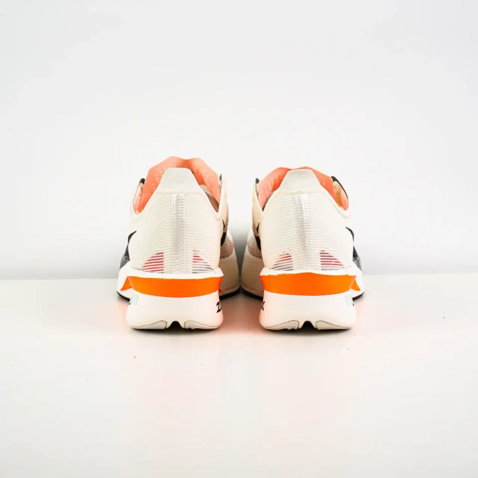 Nike ZoomX Vaporfly Next% 2 white black orange mesh sneakers viewed from the back