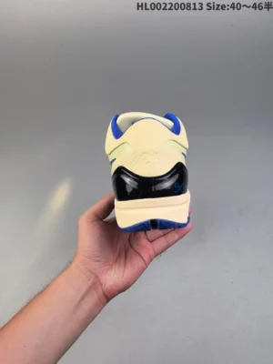 New Balance 2002R cream blue black mesh synthetic sneakers rear view held in hand