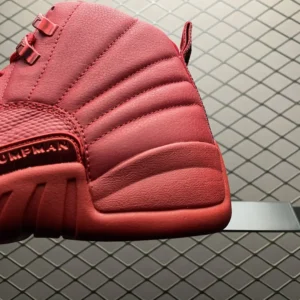 Air Jordan 12 Retro Red October red leather sneakers with metallic lace eyelets and rubber sole