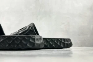 Adidas Yeezy Slide Core black EVA foam sandals with textured sole and contoured footbed