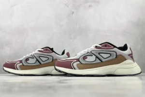 Dior B30 sneakers in white and brown color scheme, featuring prominent logo design and sporty aesthetic, showcased on a neutral background.