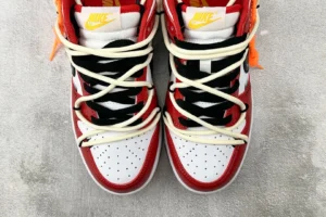 Nike Air Jordan 1 High OG Chicago red white black leather sneakers with double laces and yellow logo on tongue