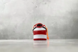 Nike Air Jordan 1 Mid red white black leather sneakers with orange zip tie detail