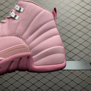 Air Jordan 12 Retro GS pink leather sneakers with metallic lace eyelets and textured midsole