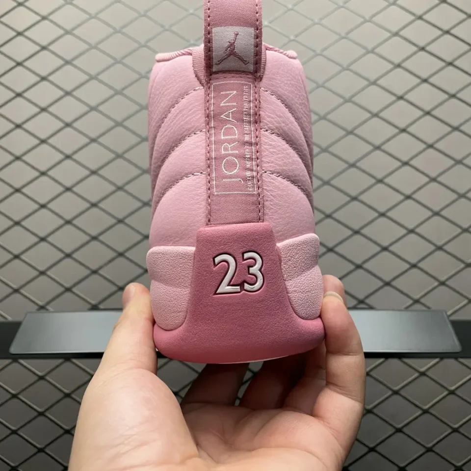 Nike Air Jordan 12 Retro GS pink colorway leather sneakers with "23" detail on heel tab