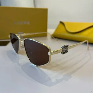 Loewe sunglasses gold frame dark lenses metal with logo detail and yellow case accessory