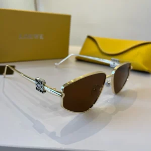 Loewe sunglasses gold metal frame brown lenses logo detail with yellow leather case and box background