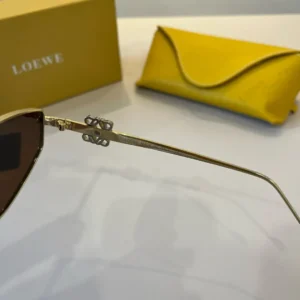 Loewe sunglasses gold metal frame brown lenses luxury accessories with brand logo detail and yellow leather case
