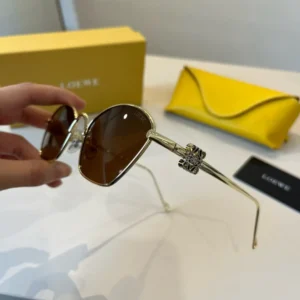 Loewe sunglasses brown lenses gold metal frame decorative hinge detail luxury eyewear accessory