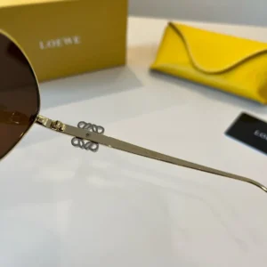 Loewe Sunglasses gold metal frame brown lenses lightweight design with Loewe box and yellow case in background