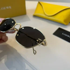 Loewe sunglasses gold metal frame black lenses lightweight design with yellow leather case