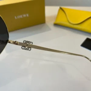 Loewe sunglasses gold metal frame black lenses signature logo detail luxury eyewear