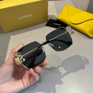 Loewe sunglasses black lenses gold metal frame luxury accessories with yellow case and branded box